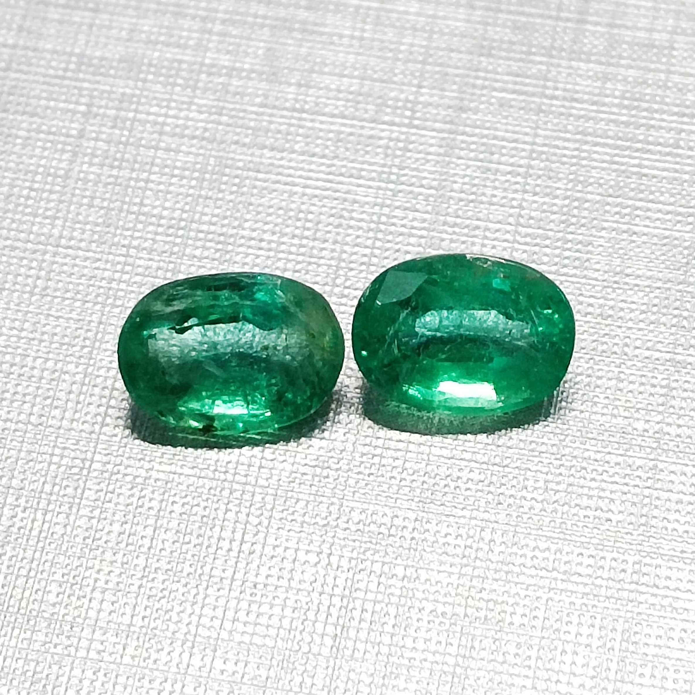 3.55ct vivid green oval mix cut emerald pair