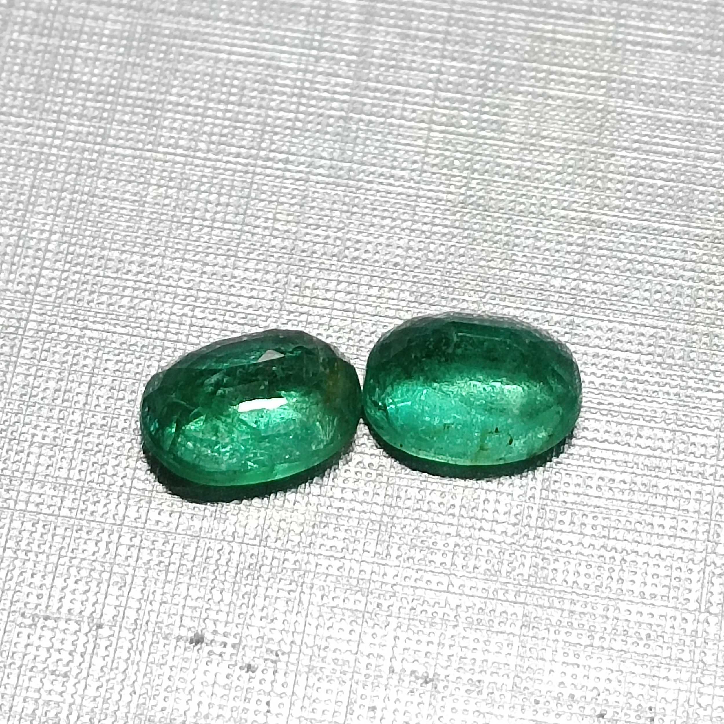3.55ct vivid green oval mix cut emerald pair
