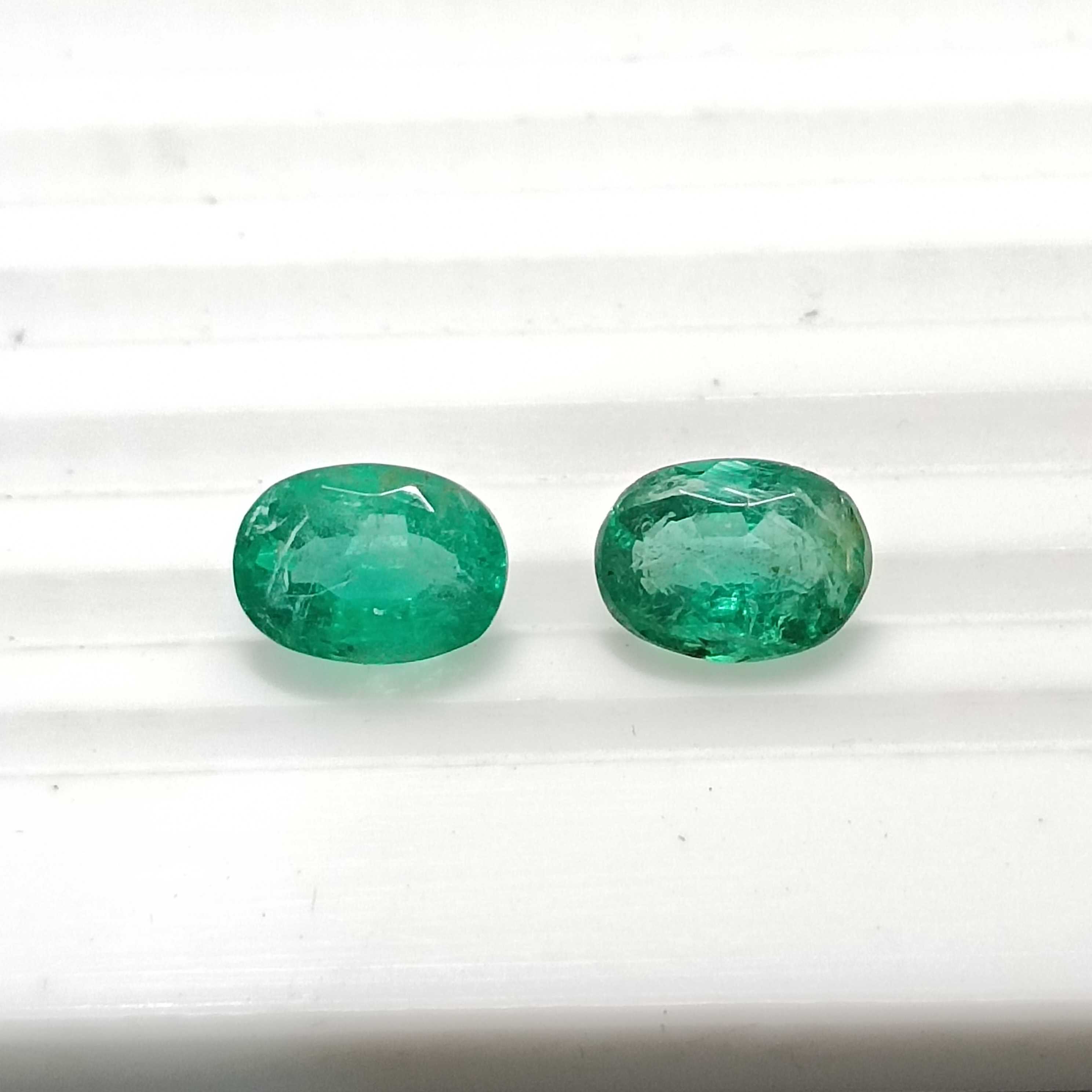 3.55ct vivid green oval mix cut emerald pair